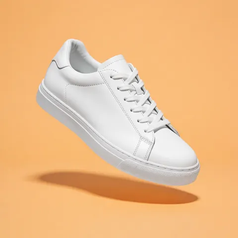White sneaker on orange background